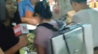 Woman in Shanghai Wears 15 kg Air Purifying ‘Mask’ When Shopping