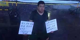 Man Kneels in City Square in the Rain Asking for Wife's Forgiveness